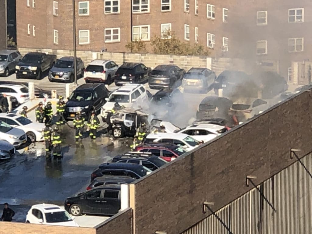 Firefighters hose down burning vehicles at Mount Sinai garage