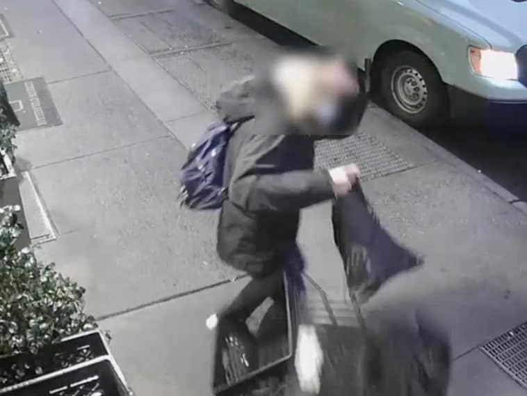 Victim clutches her head in pain after assault outside Butterfield Market/NYPD Crime Stoppers