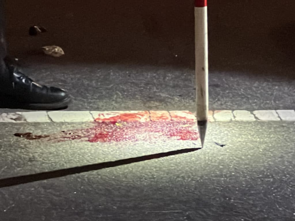 Blood stains the pavement where the crash occurred/Upper East Site
