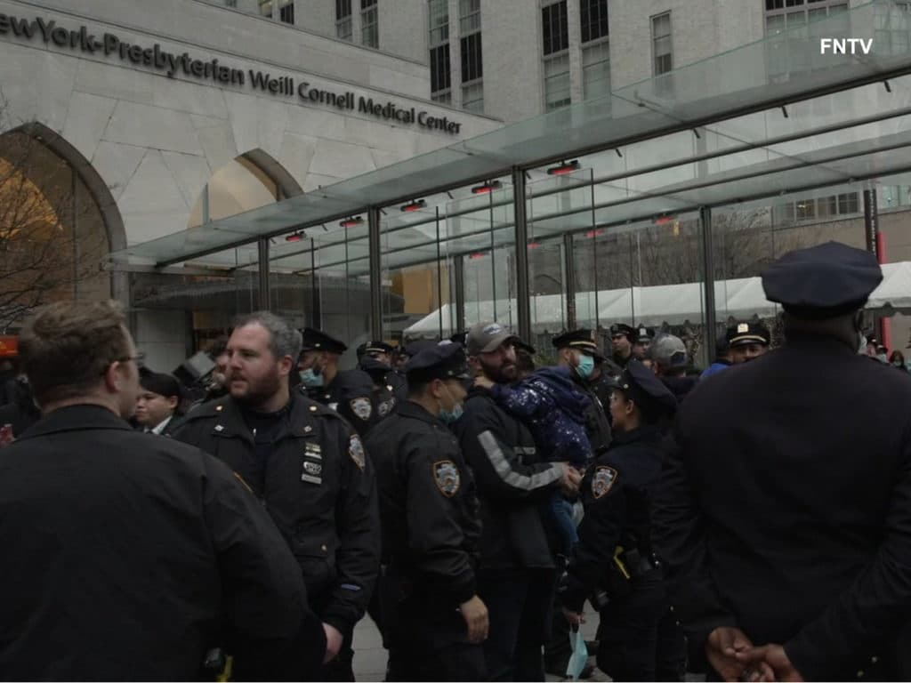 Officers gather outside New York-Presbyterian Hospital where wounded officer was treated/Oliya Scootercaster, FNTV