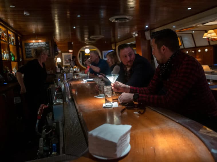People enjoy cocktails inside SoHo’s Lure Fishbar, Feb. 28, 2022