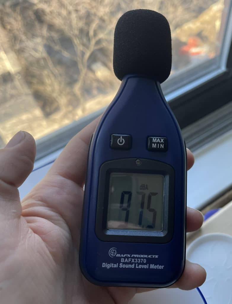 Noise meter shows 97.5 decibels indoors with windows closed