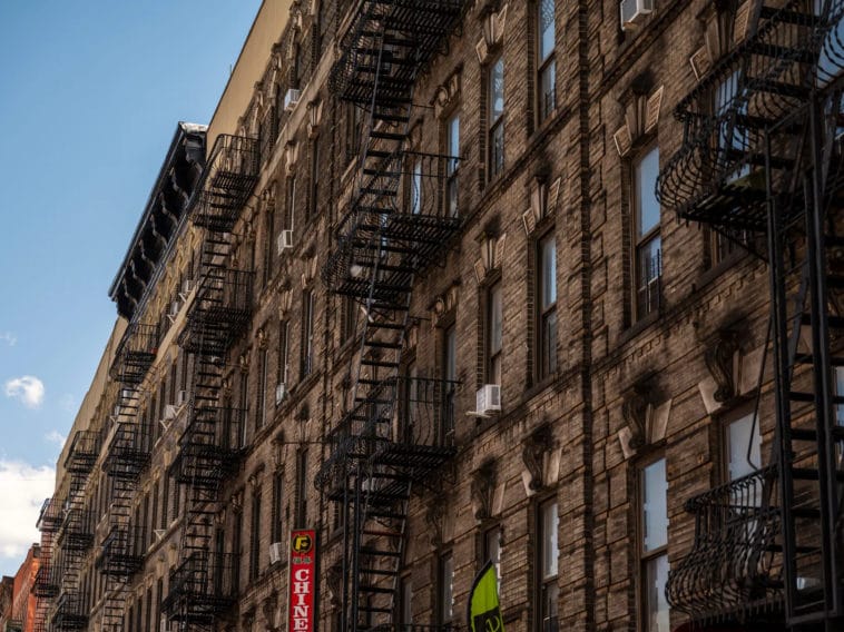 A row of South Bronx tenement buildings held a mix of apartments and businesses on he ground floor, April 8, 2022