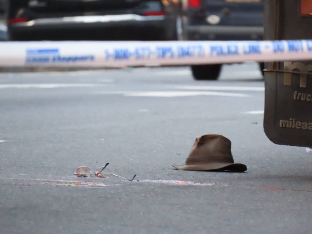 Crash victim's glasses and fedora lay in the street next to blood stains/Upper East Site