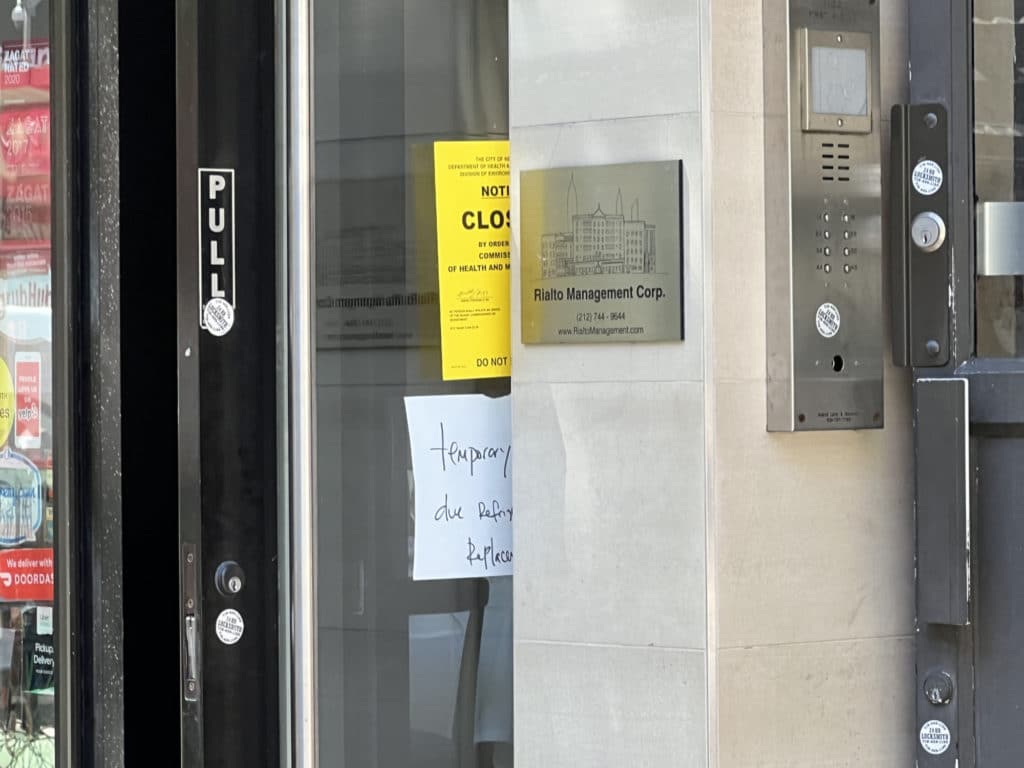 Ravagh Persian Grill's door is propped open, obscuring the closure notice/Upper East Site