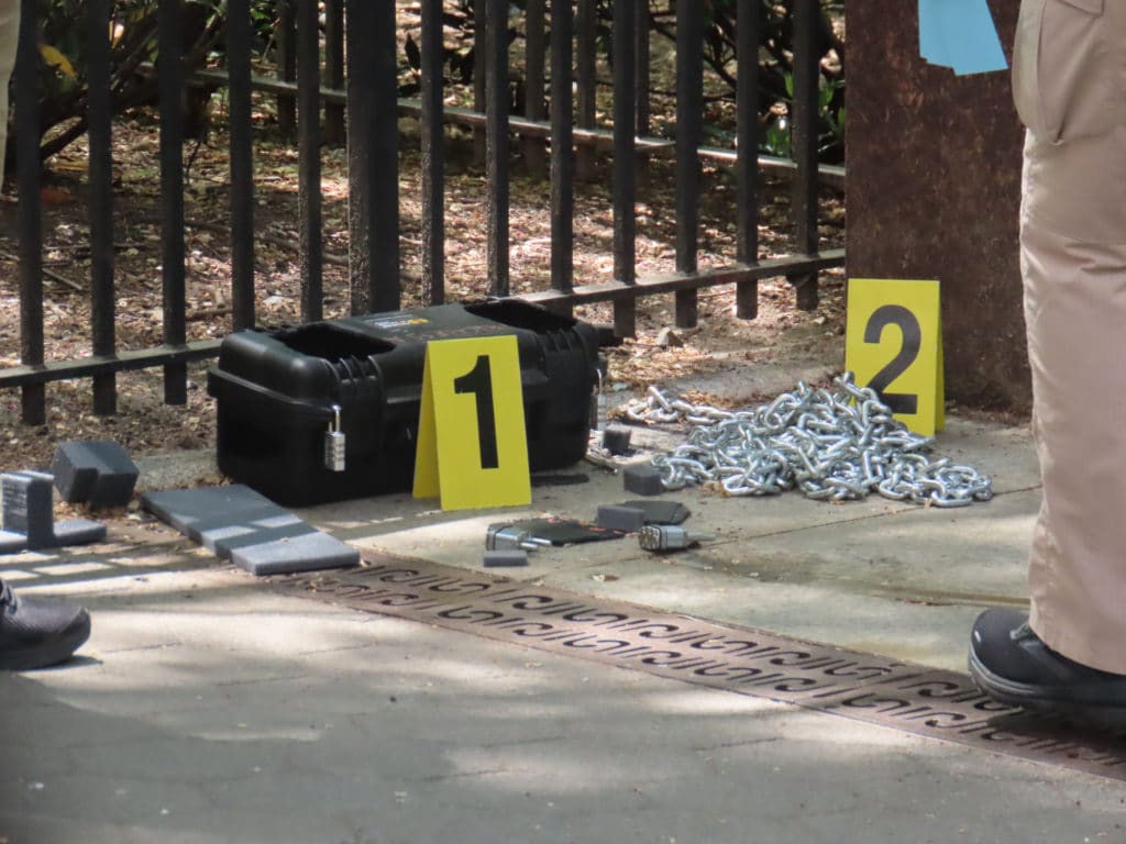 Crime scene investigators examine black box and chain/Upper East Site