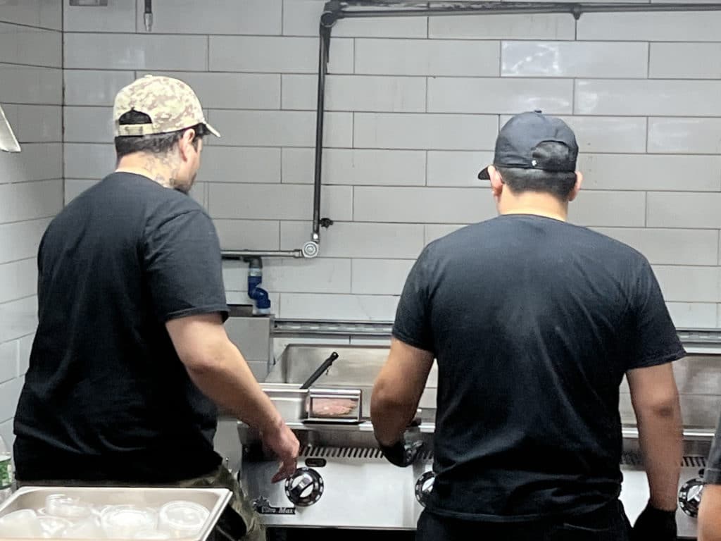 See your burger get cooked in 7th Street Burger's open kitchen | Upper East Site