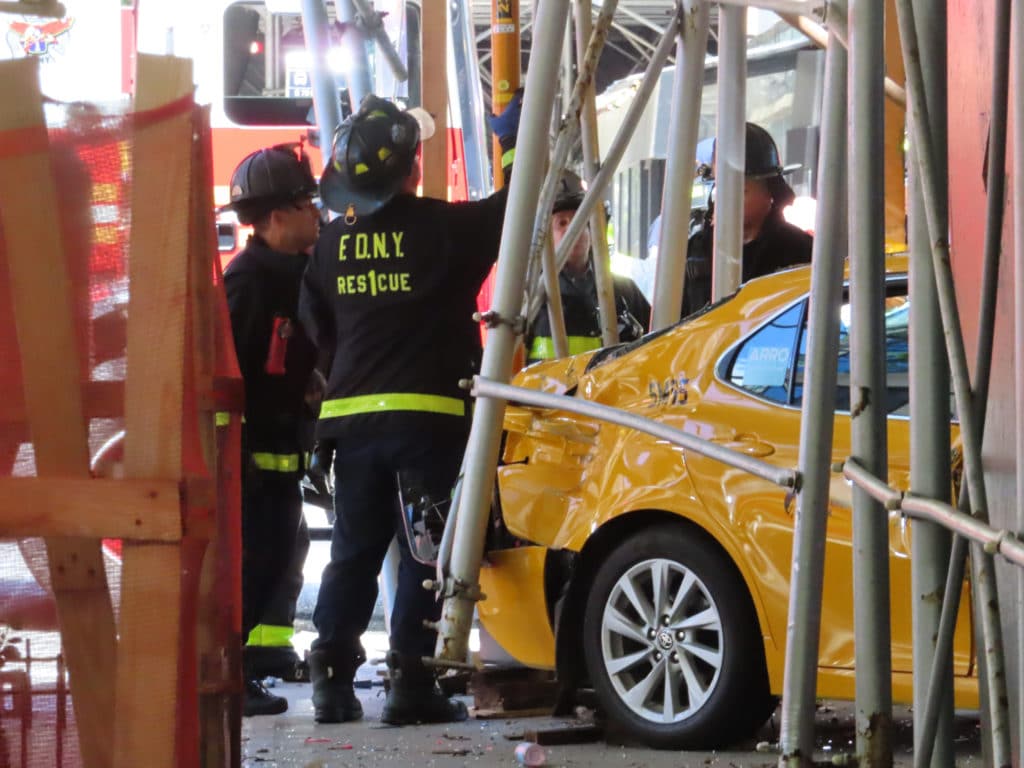 Firefighters work to secure the unstable scaffolding and sidewalk shed after the crash | Upper East Site