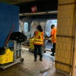MTA workers clean an E train at Jamaica Center, July 13, 2022 | Jose Martinez/THE CITY