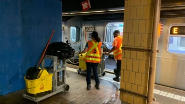 MTA workers clean an E train at Jamaica Center, July 13, 2022 | Jose Martinez/THE CITY