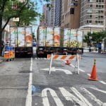 Triple-parked Fresh Direct Trucks block traffic on Third Avenue as barriers block turn lane