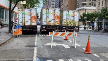 Triple-parked Fresh Direct Trucks block traffic on Third Avenue as barriers block turn lane