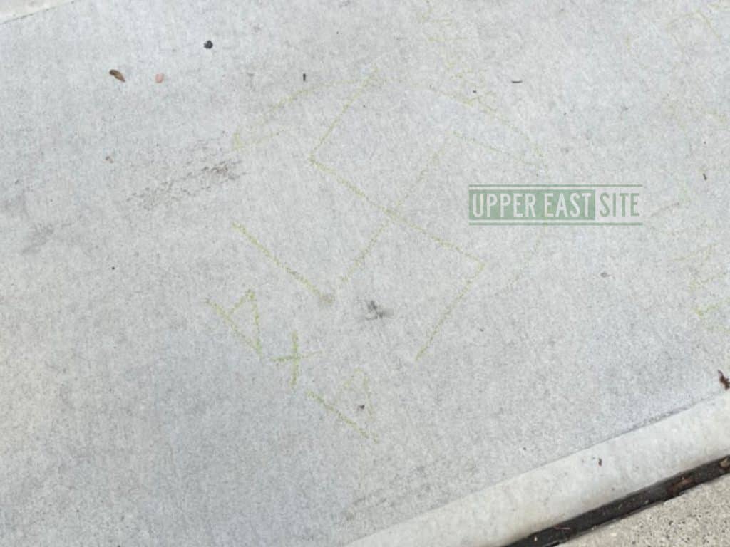 Yellow swastika scrawled on sidewalk along East 60th Street between First and York Avenues 