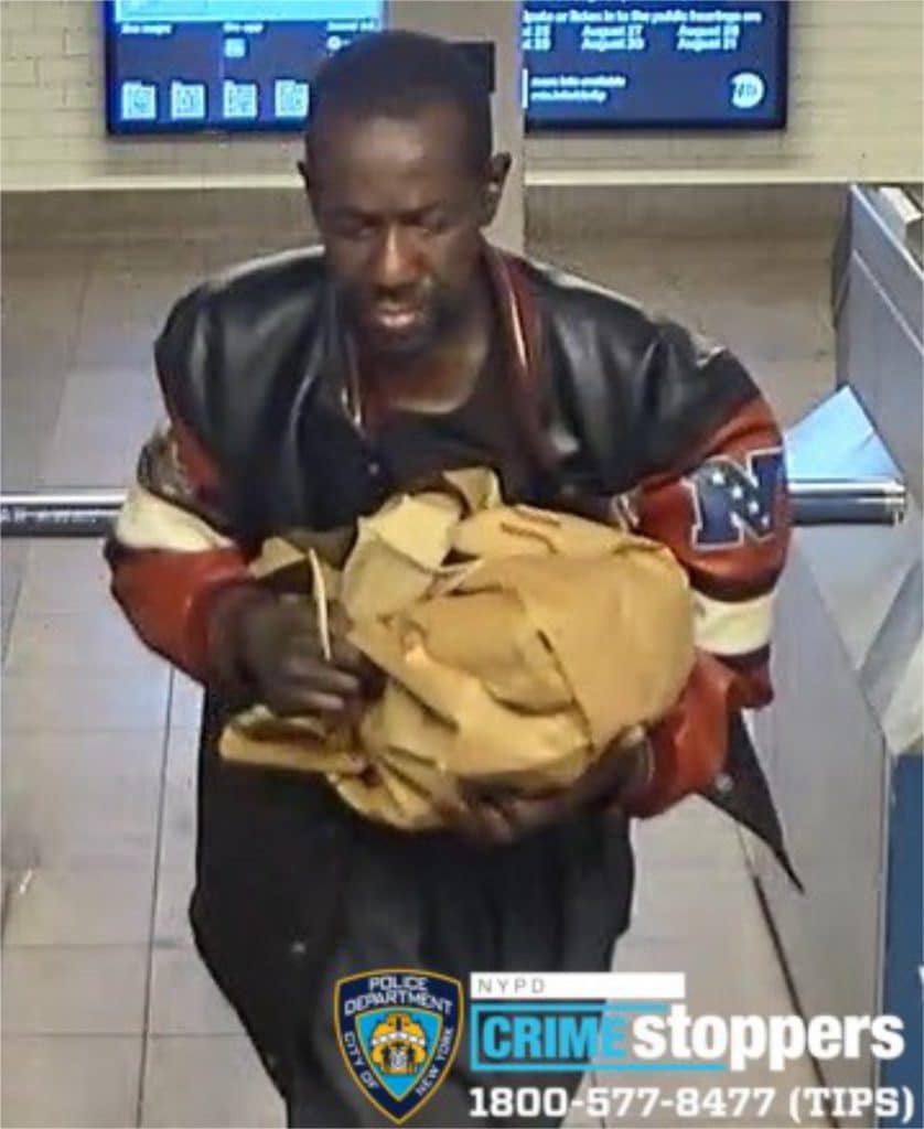 The suspect is seen on surveillance video carrying a brown paper bag | NYPD