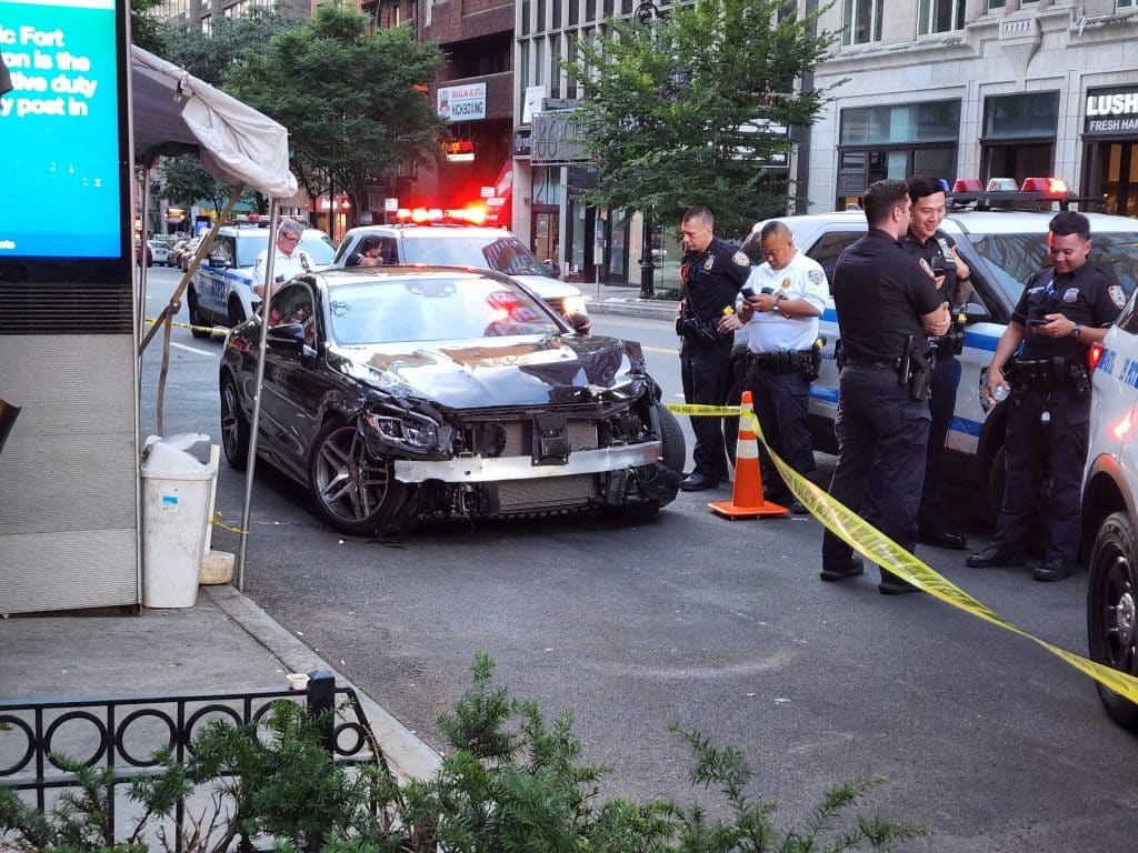 The suspects' smashed up black Mercedes was abandoned on East 86th Street