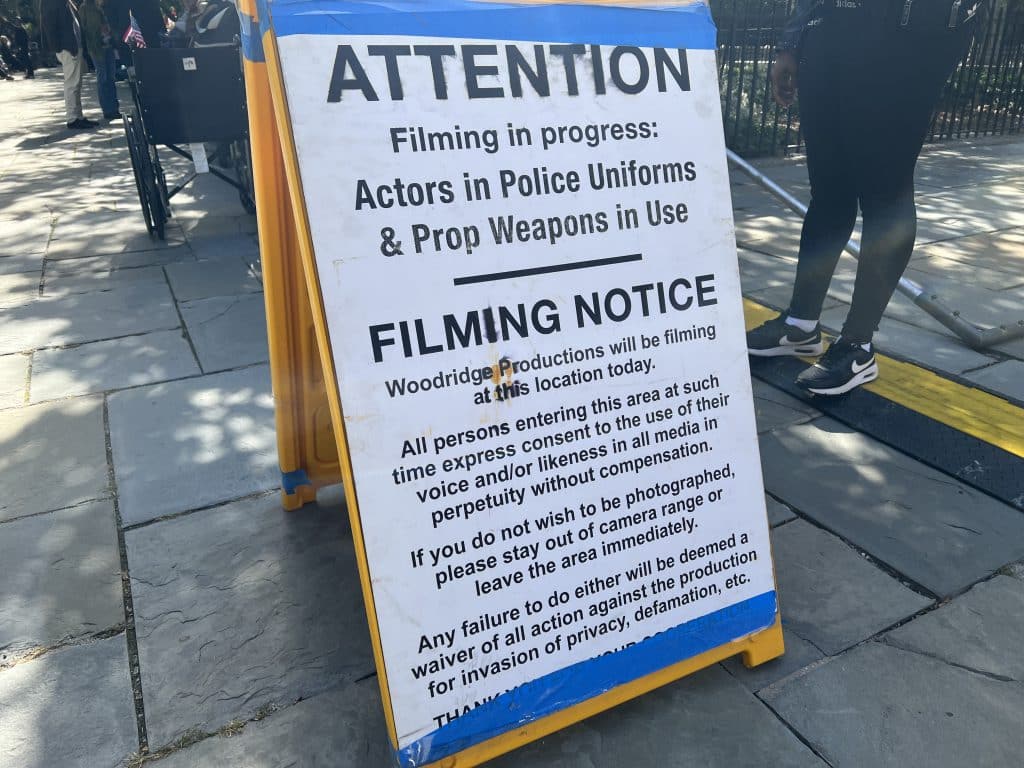 Sign warns actors are dressed like police and prop weapons are in use | Upper East Site
