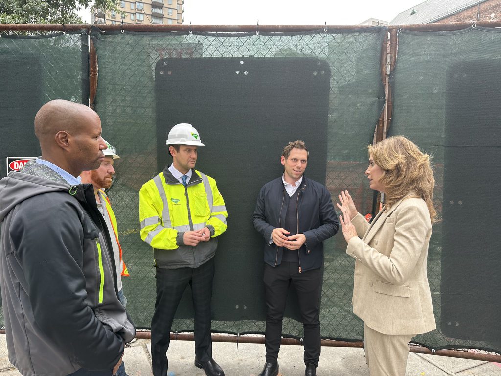 Council Member Julie Menin (right) walked through the noisy construction site with representatives from Extell