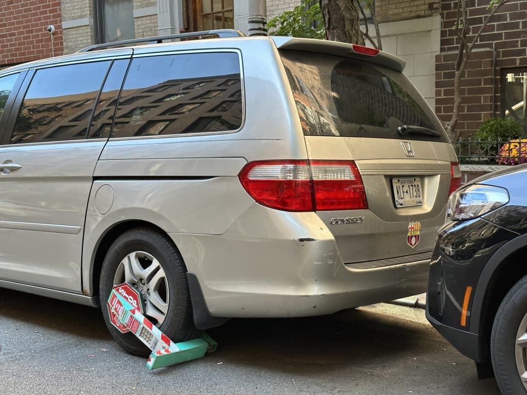 A Honda minivan remains booted on East 91st Street weeks after the device was installed | Upper East Site 