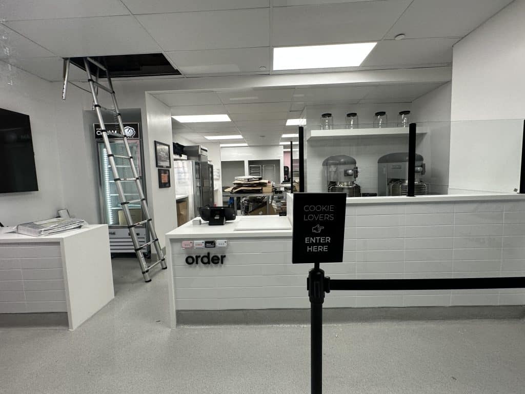 Behind the counter are two dough mixers and an ice cream freezer | Upper East Site