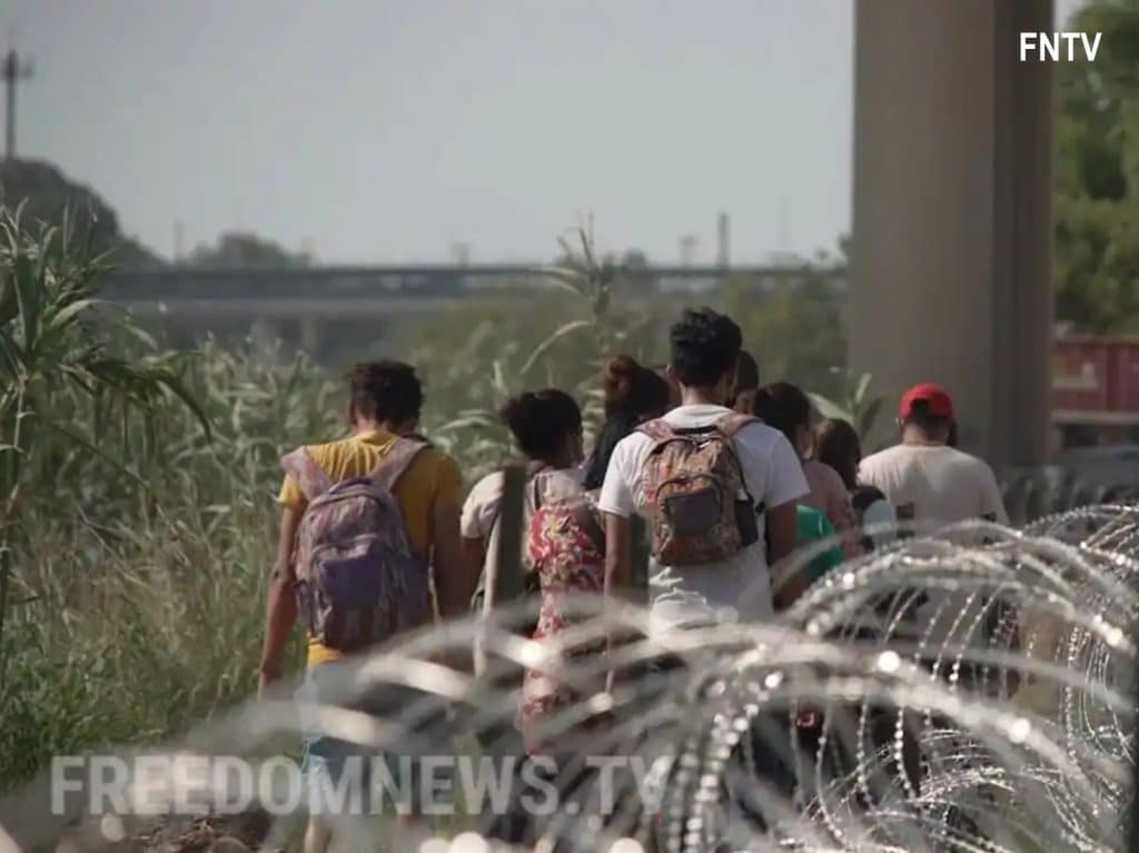 Migrants cross into the United States in Eagle Pass, Texas in May 2022