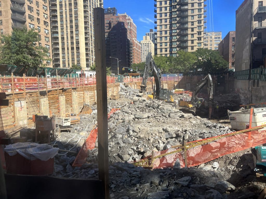 Excavators equipped with giant jackhammers are chiseling through 40 feet of bedrock | Upper East Site
