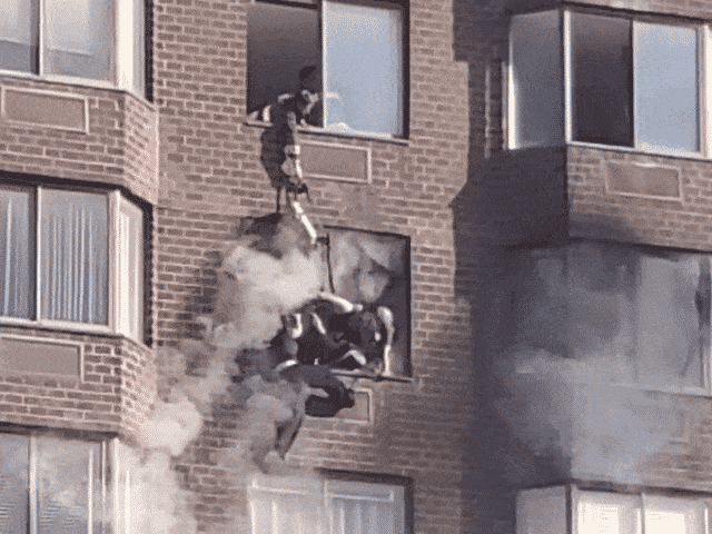 FDNY crew performs rope rescue to save woman dangling from burning high-rise