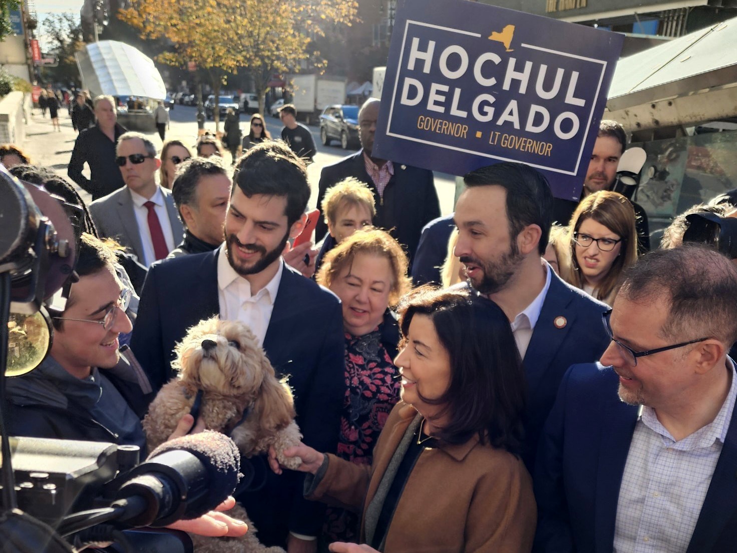Gov. Kathy Hochul shakes a dog's paw as she campaigns on the Upper East Side