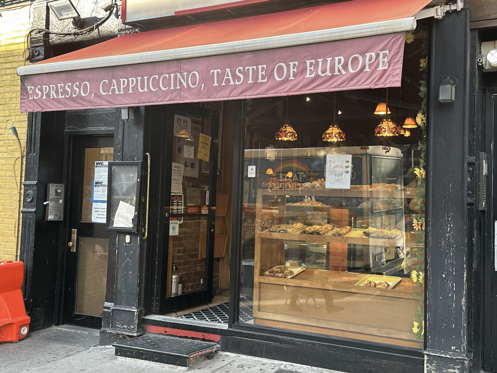 Budapest Cafe's door is propped open, making the yellow closure notice difficult to see | Upper East Site
