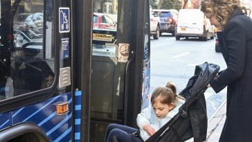 Council Member Julie Menin and her daughter, in a stroller, board an M31 bus on the Upper East Side | Marc A. Hermann/MTA