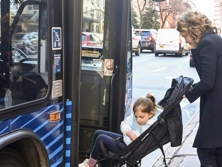 Council Member Julie Menin and her daughter, in a stroller, board an M31 bus on the Upper East Side | Marc A. Hermann/MTA
