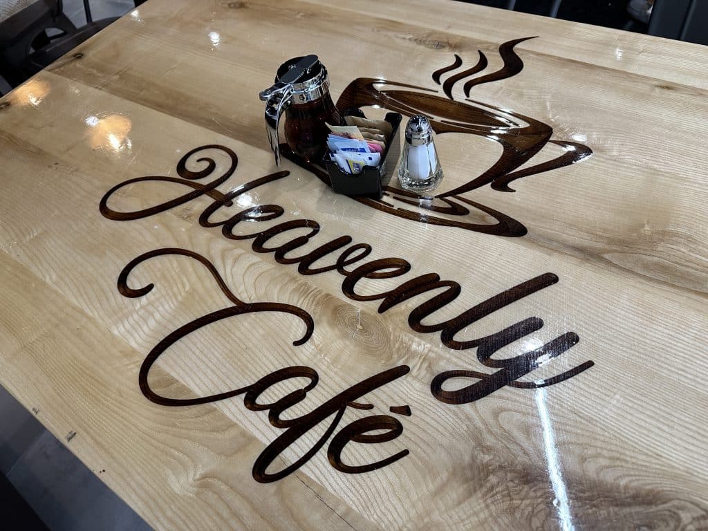Tables are laser-engraved with Heavenly Cafe's logo | Upper East Site