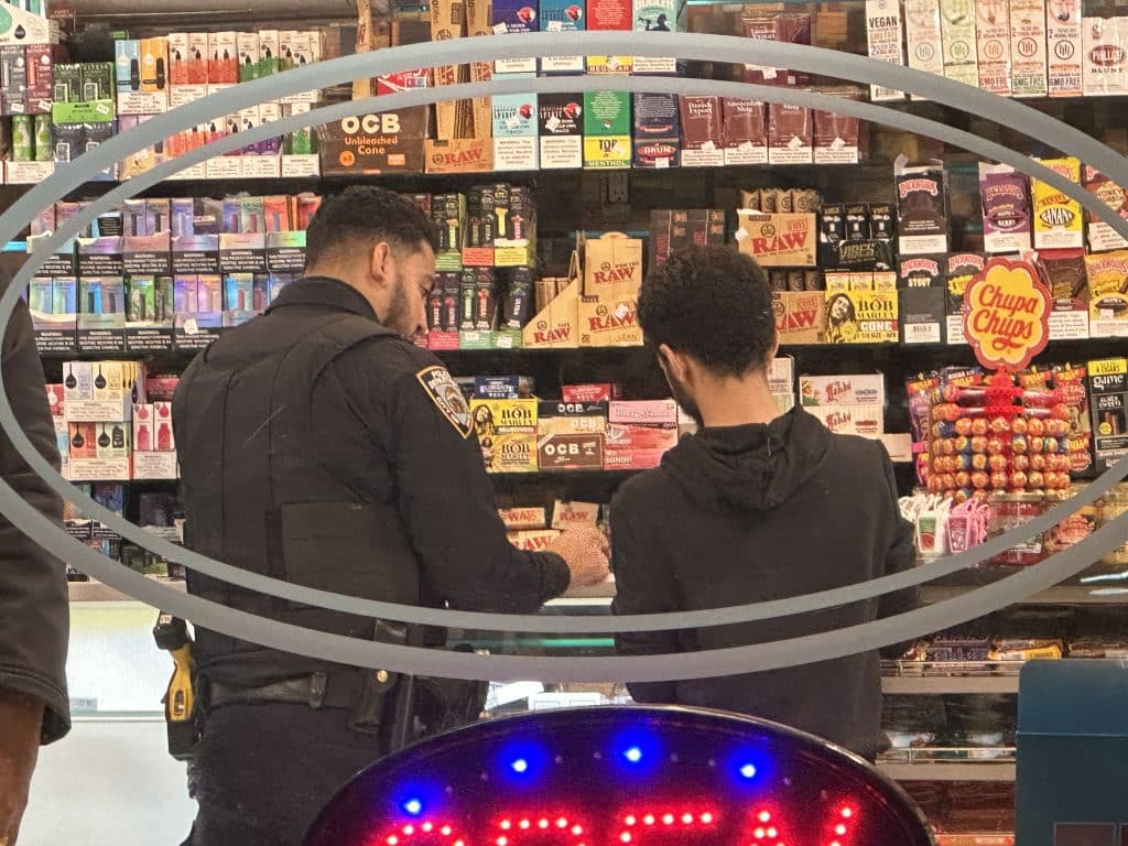 An officer was seen interviewing the smoke shop's clerk after the robbery | Upper East Site