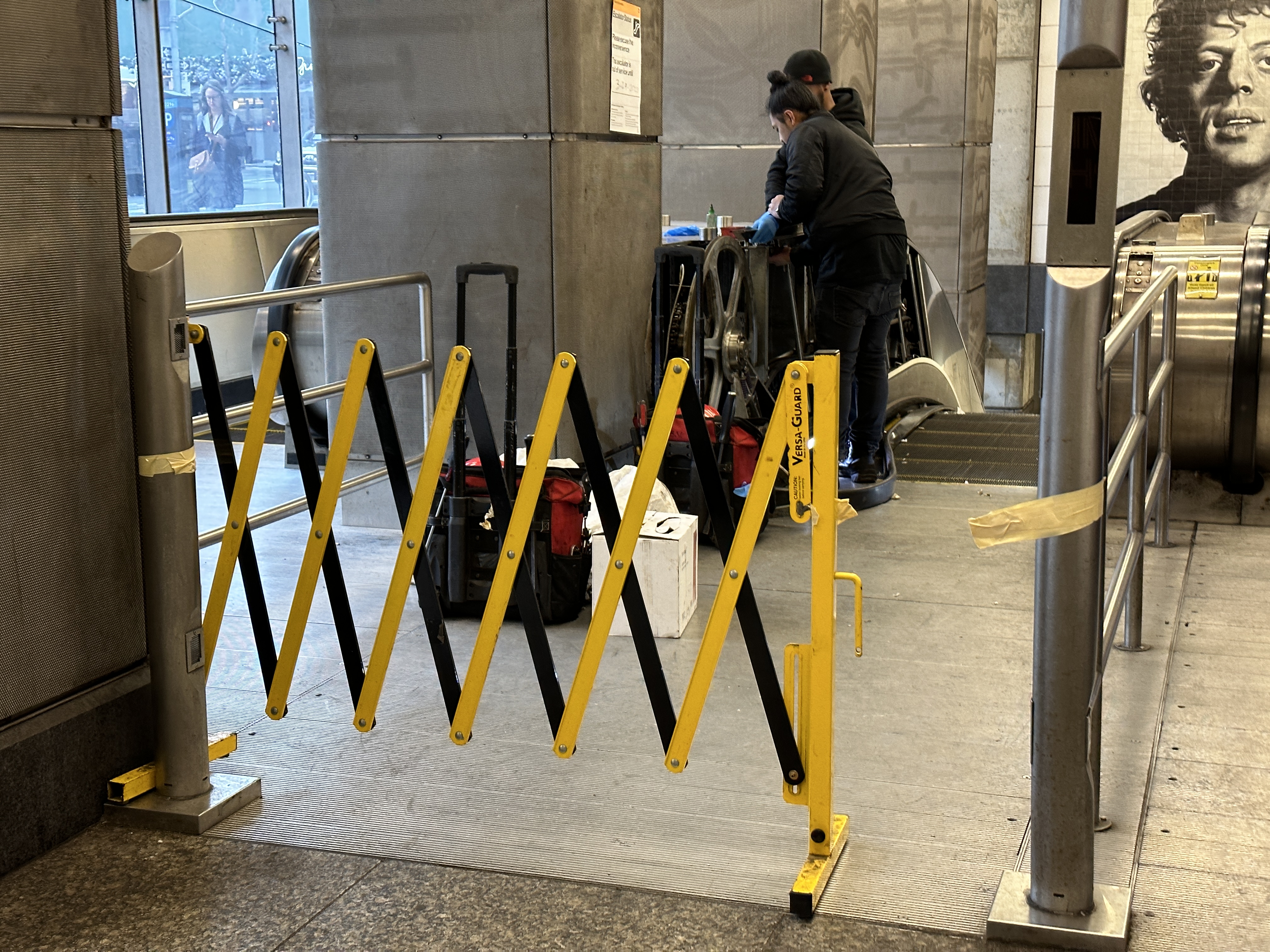 Contractors were seen making repairs to the broken escalator on Tuesday | Upper East Site