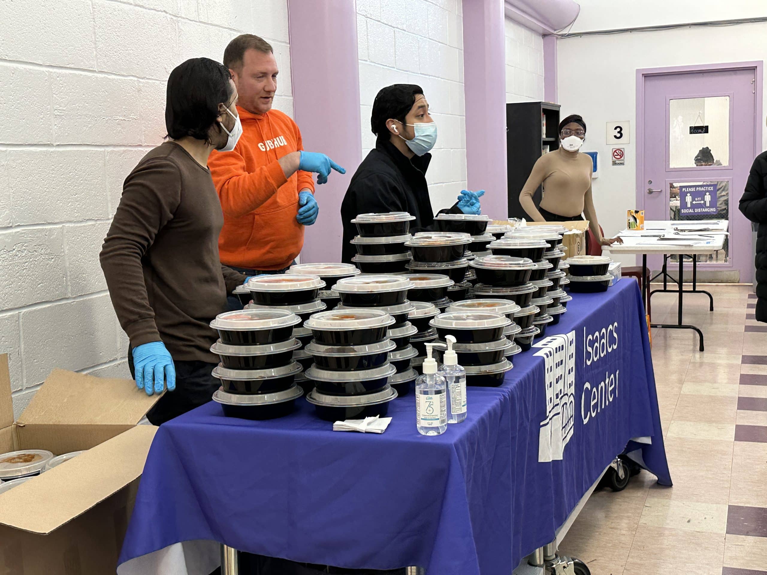 Brett Swanson from Grubhub (in orange) spent roughly 15 mins stacking meals instead of handing them out directly to the hungry UES seniors | Upper East Site