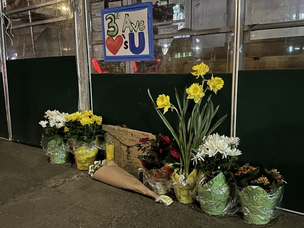 Neighbors have set up a makeshift memorial with flowers and candles outside Daona deli | Upper East Site