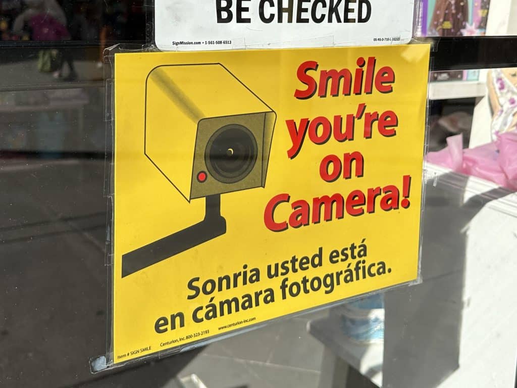 A large sign on the front door of Lisa's on Seconds warns shoplifters they will be recorded | Upper East Site