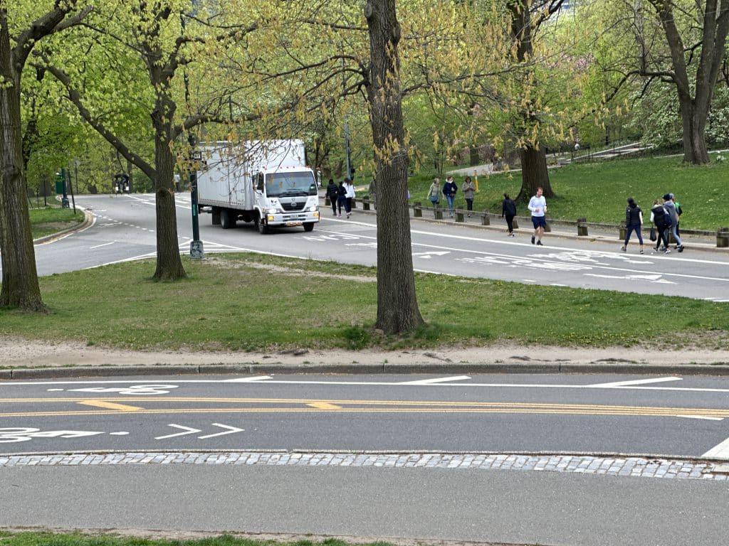 Pedestrians, bicyclists, motorcycles, authorized  cars and trucks all share Park Drive in Central Park | Upper East Site