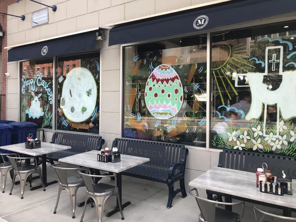The window paintings include eggs, crosses and a Seder plate marking Passover | Nora Wesson/Upper East Site