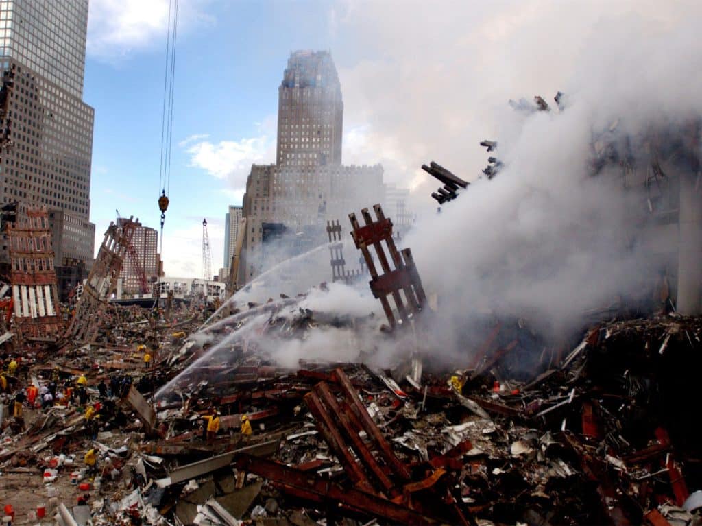 Firefighters work to extinguish the the smoldering wreckage of the World Trade Center on 9/13/01 | Jim Watson/US Navy