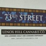Photo shows a white printed sign on glass with a subway tile mosaic reading 73rd Street.' Underneath it is the Lenox Hill Cannabis Co. name and 'UES LICENSED ADULT USE CANNABIS DISPENSARY'