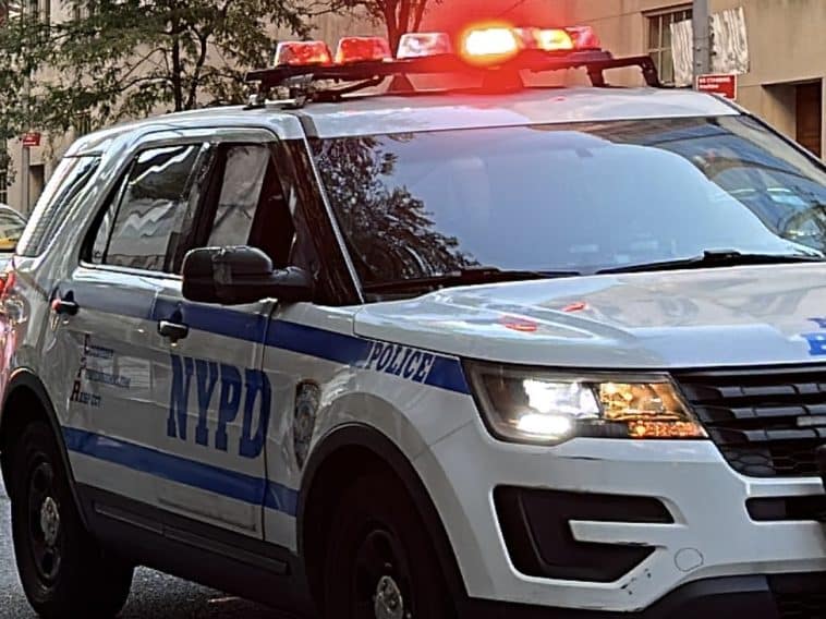 Photo shows an NYPD SUV with its lights flashing