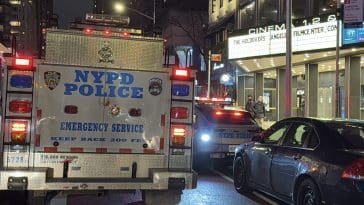 Photo shows an NYPD truck parked outside Cinema 123 where blood was found on the sidewalk