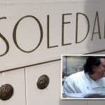 Composite shows a close up of a gold hand-painted logo on a pink painted door reading SOLEDAD. Inset is a photo of a chef in a kitchen as seen through the restaurant pass from the front of house side.