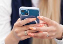 Photo shows hands holding a cell phone like the person is reading something