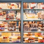 Photo shows a display case filled with assorted desserts.