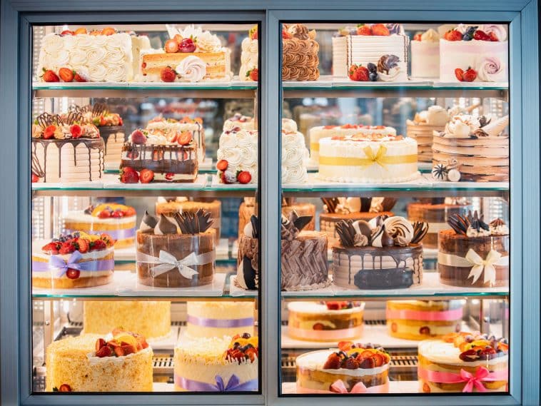 Photo shows a display case filled with assorted desserts.