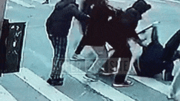 Gif shows surveillance video of a group mercilessly assaulting a man on the street.