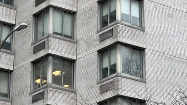 Photo shows a close up of windows on an apartment building.