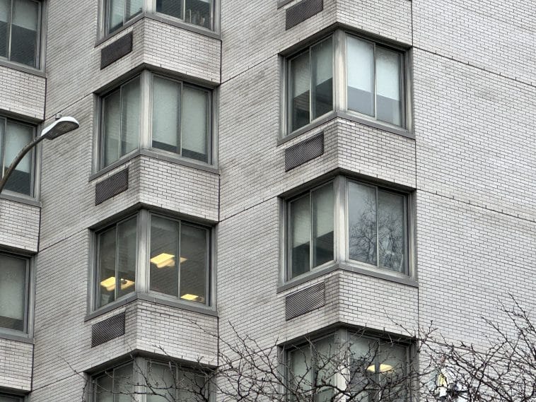 Photo shows a close up of windows on an apartment building.