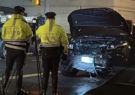 Photo shows police investigating a crash involving a black SUV.